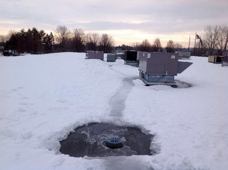 roof-drains-cleared-of-snow Roof drain cleared of snow