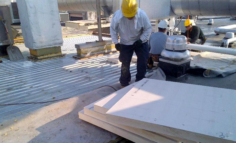 polyisocyanurate-insulation Polyisocyanurate insulation being installed on a commercial roof